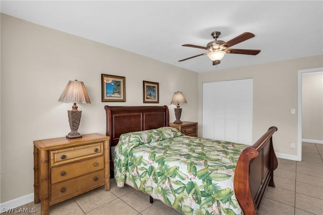 tiled bedroom featuring ceiling fan