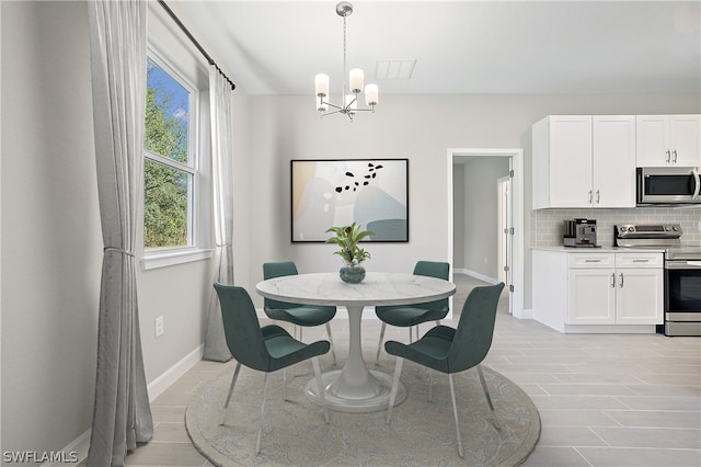 tiled dining area with a notable chandelier