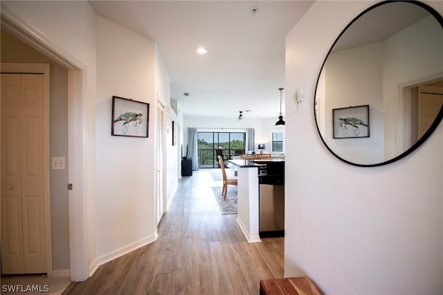 corridor with light hardwood / wood-style flooring