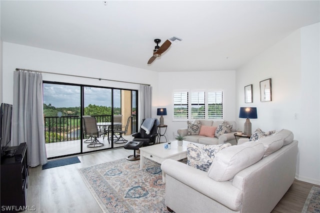 living room featuring ceiling fan and light hardwood / wood-style floors