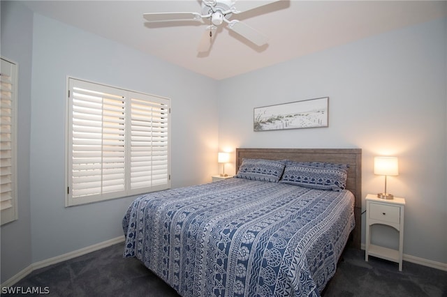 bedroom with ceiling fan and dark carpet