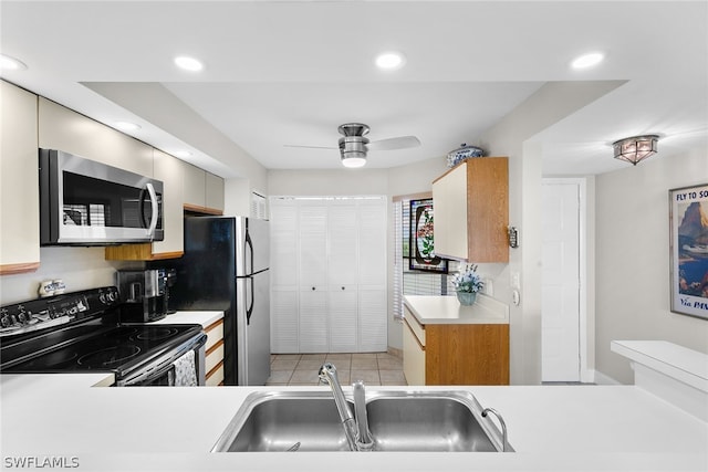 kitchen featuring sink, ceiling fan, black range with electric stovetop, and light tile floors