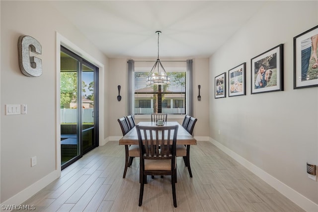 dining space with a notable chandelier and light wood-type flooring