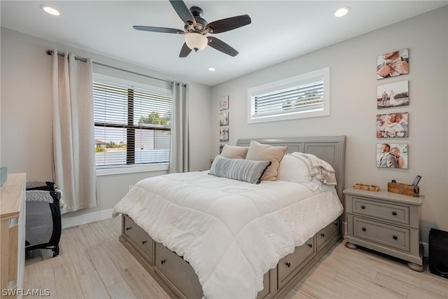 bedroom with ceiling fan and light hardwood / wood-style floors