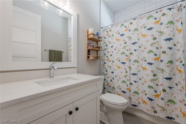 bathroom with hardwood / wood-style flooring, toilet, and vanity