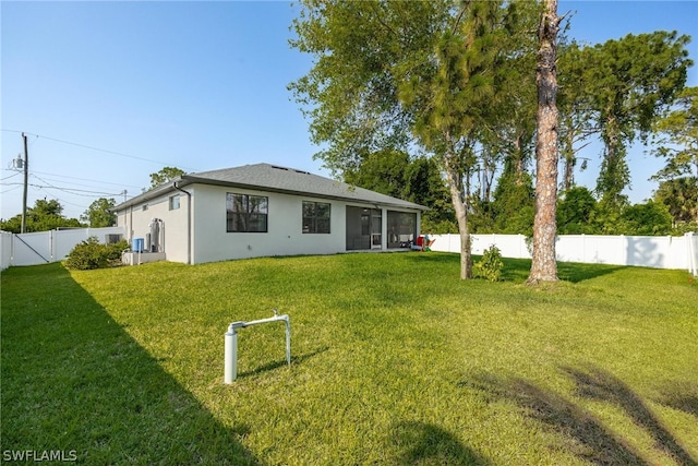 back of house featuring a lawn