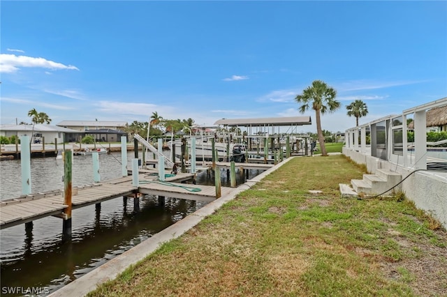 dock area with a water view and a yard