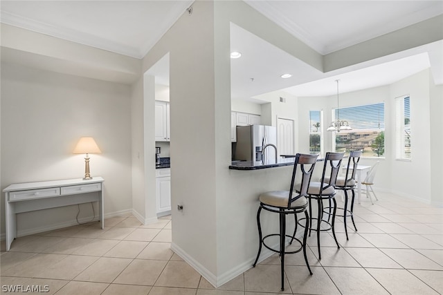 kitchen featuring stainless steel fridge with ice dispenser, white cabinets, kitchen peninsula, a breakfast bar, and light tile floors