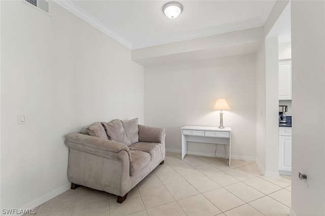 living area with ornamental molding and light tile floors