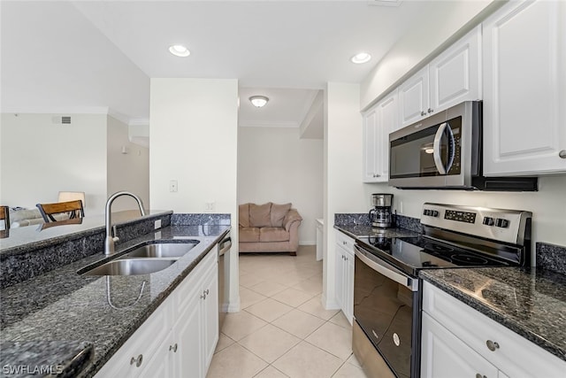 kitchen with white cabinets, appliances with stainless steel finishes, sink, and crown molding