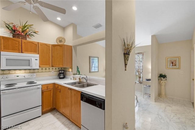 kitchen with decorative backsplash, white appliances, vaulted ceiling, ceiling fan, and sink