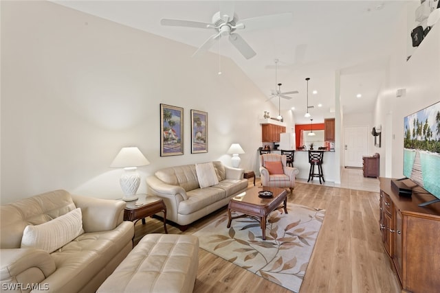 living room featuring high vaulted ceiling, ceiling fan, and hardwood / wood-style floors