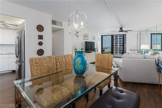 interior space featuring ceiling fan with notable chandelier and dark hardwood / wood-style flooring