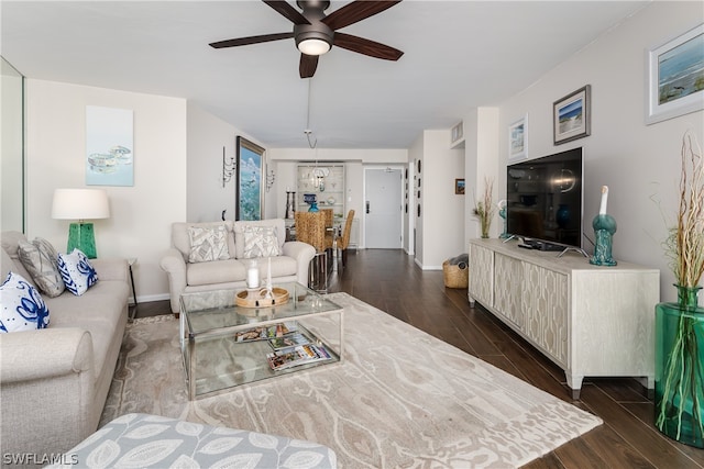 living room featuring dark wood-type flooring and ceiling fan