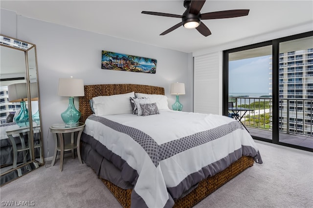 carpeted bedroom featuring ceiling fan, access to exterior, and a water view