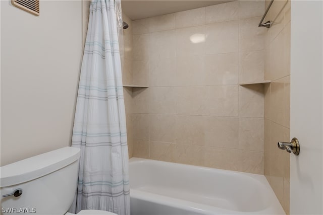 bathroom with shower / tub combo with curtain and toilet