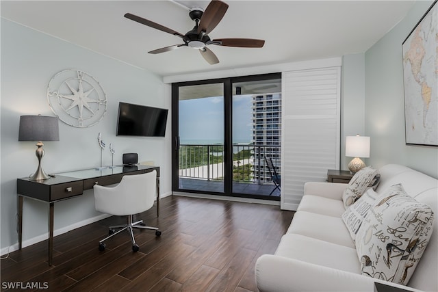 home office featuring floor to ceiling windows, dark wood-type flooring, and ceiling fan