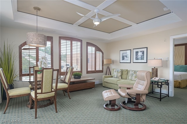 living room with a raised ceiling, carpet, and ceiling fan