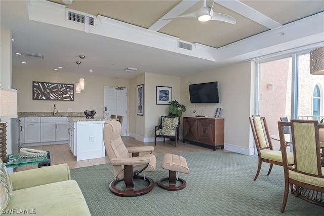 living room featuring ceiling fan and sink