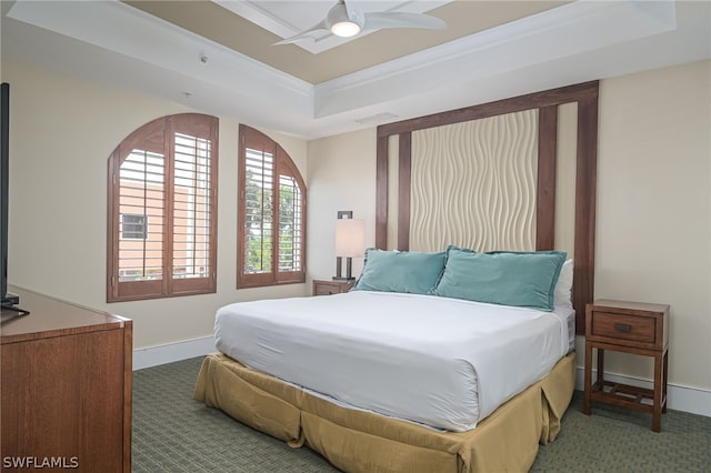 bedroom featuring carpet flooring, ceiling fan, and a raised ceiling