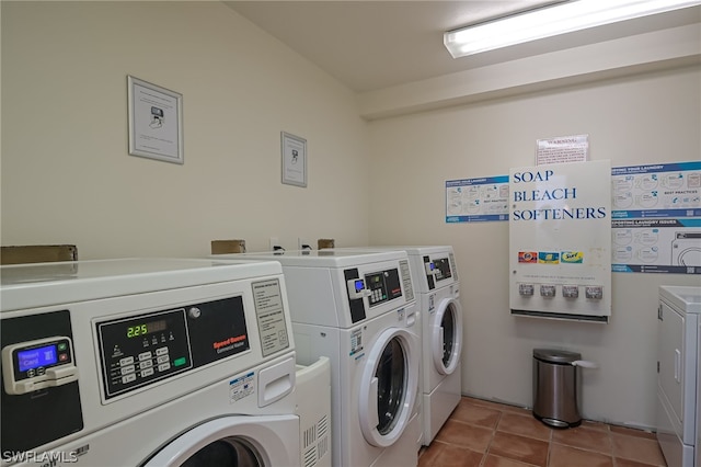 laundry room featuring washer and clothes dryer and light tile floors