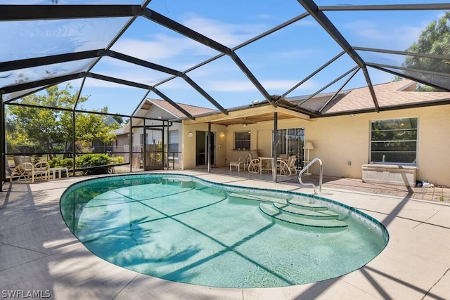 view of pool featuring a patio area and glass enclosure