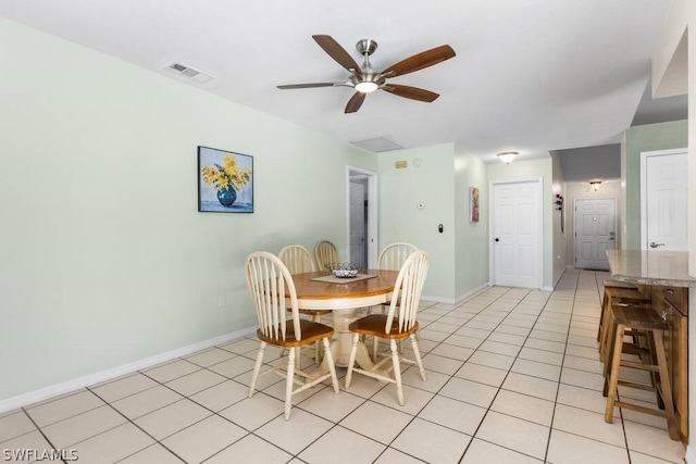 tiled dining space with ceiling fan