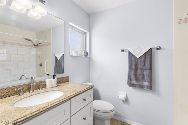 bathroom with tile flooring, toilet, and vanity