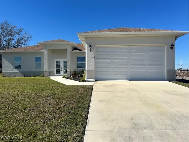 view of front of property with a garage, a front yard, and french doors