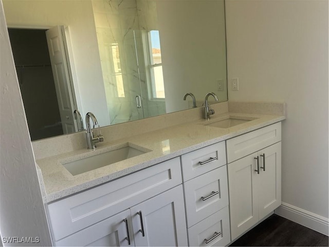 bathroom featuring vanity and a shower with door