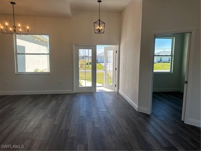 doorway to outside featuring dark hardwood / wood-style floors and an inviting chandelier