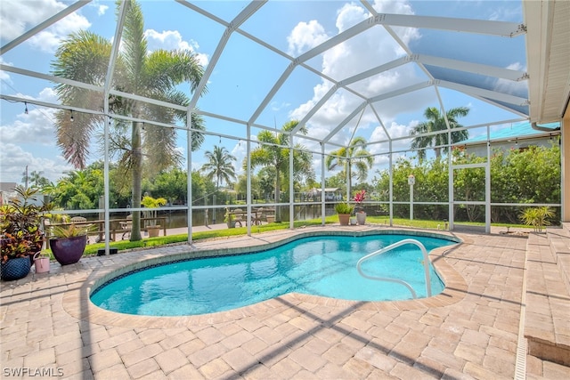 view of swimming pool with a patio area and a lanai