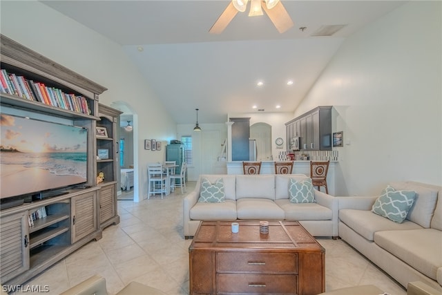 tiled living room featuring vaulted ceiling and ceiling fan