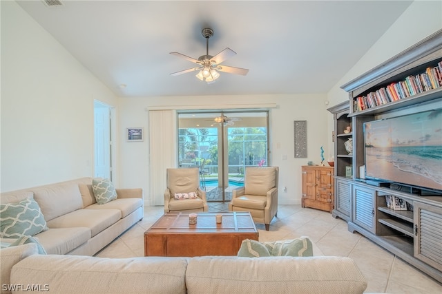 living room featuring ceiling fan, light tile floors, and lofted ceiling