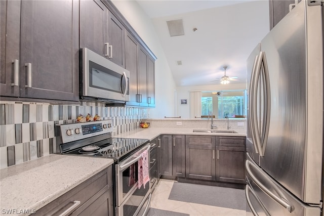 kitchen featuring light tile flooring, ceiling fan, tasteful backsplash, appliances with stainless steel finishes, and sink