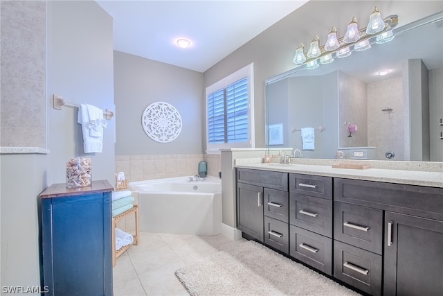 bathroom featuring a bath, tile floors, and oversized vanity