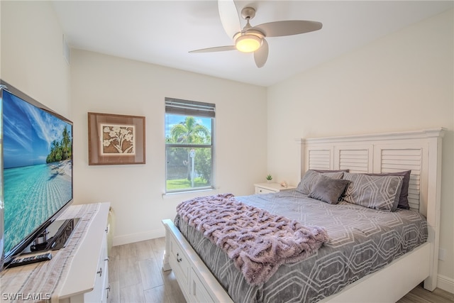 bedroom with ceiling fan and light wood-type flooring