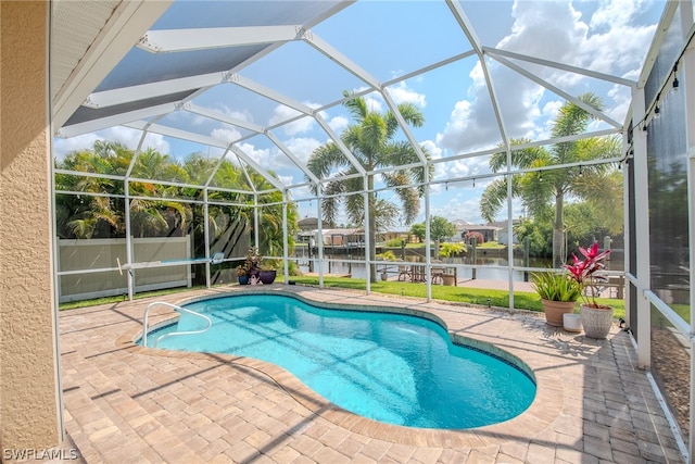 view of pool featuring a patio and glass enclosure