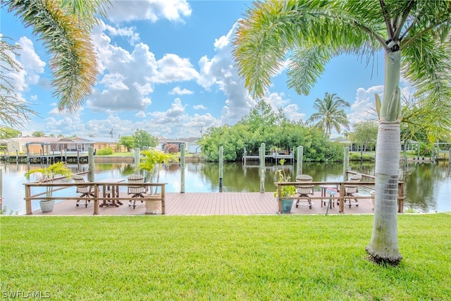 dock area featuring a lawn and a water view