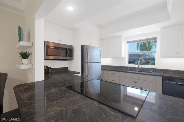 kitchen with white cabinetry, appliances with stainless steel finishes, sink, and crown molding