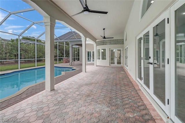 outdoor pool with ceiling fan, french doors, a patio area, and a lanai