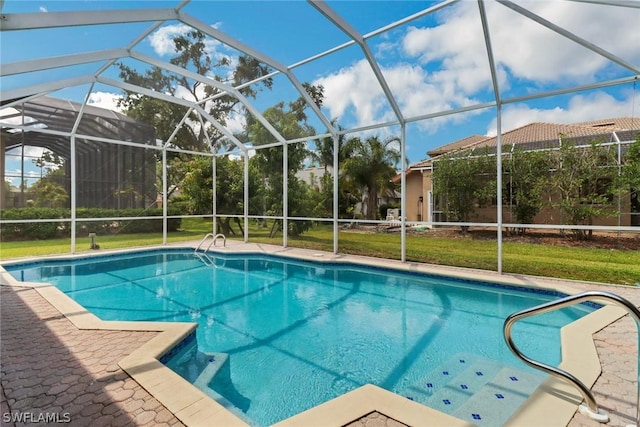 outdoor pool featuring glass enclosure, a yard, and a patio