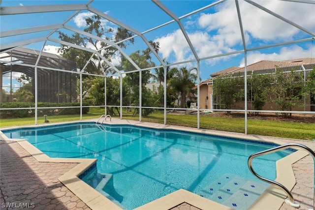 pool featuring glass enclosure, a yard, and a patio