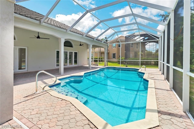 outdoor pool featuring a lanai, a patio area, french doors, and a ceiling fan