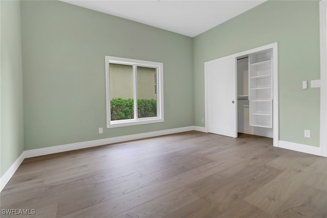 unfurnished bedroom featuring a closet and light hardwood / wood-style flooring