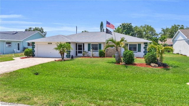 ranch-style house with a front yard and a garage