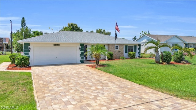 ranch-style home featuring a garage and a front yard