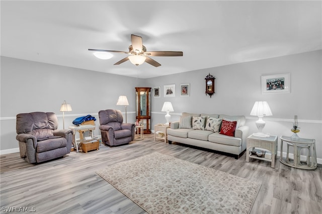 living room featuring light hardwood / wood-style floors and ceiling fan