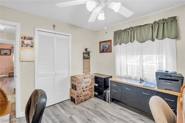 office with ceiling fan and light hardwood / wood-style floors