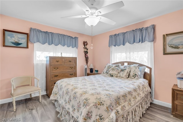 bedroom with ceiling fan and hardwood / wood-style flooring